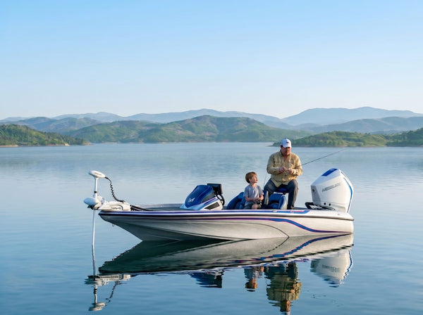 Bass fishing boat with electric trolling motor on calm lake at sunset, father and child fishing.